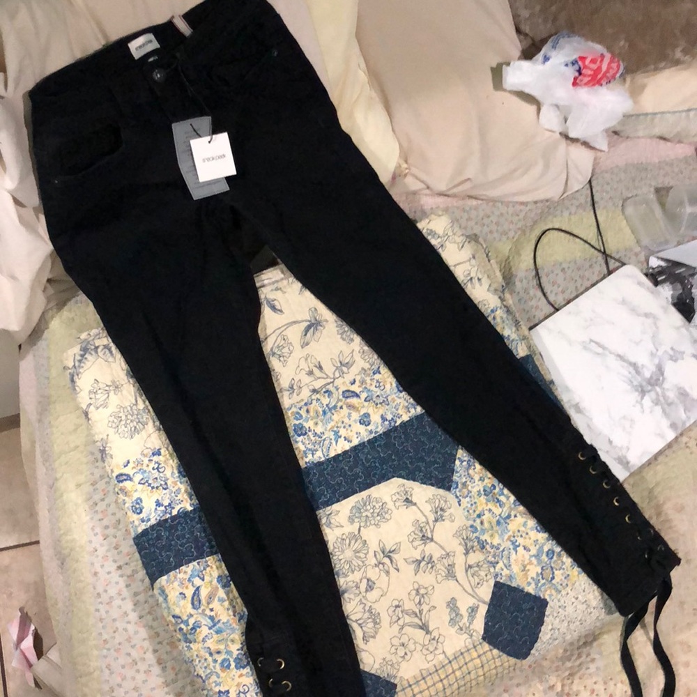 Midrise black jeans. Lace up from ankles